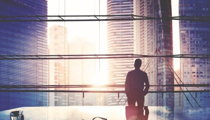 A leader silhouetted against a city skyline