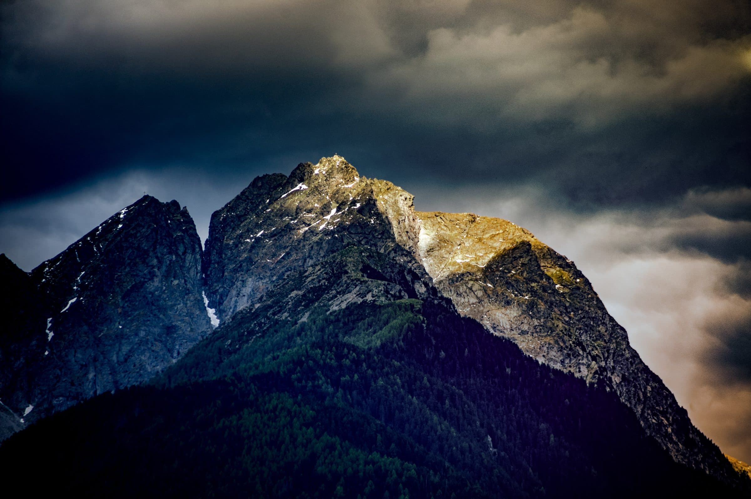 A storm-lit mountain peak