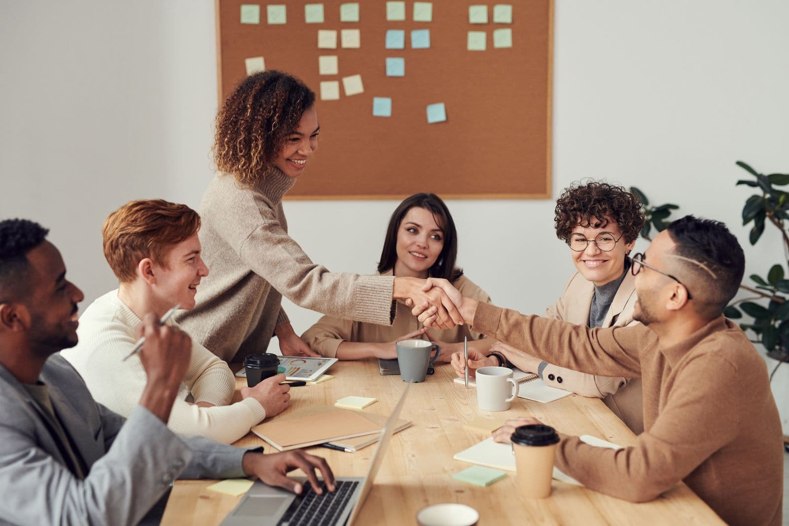 A leadership team in conversation around a glass table